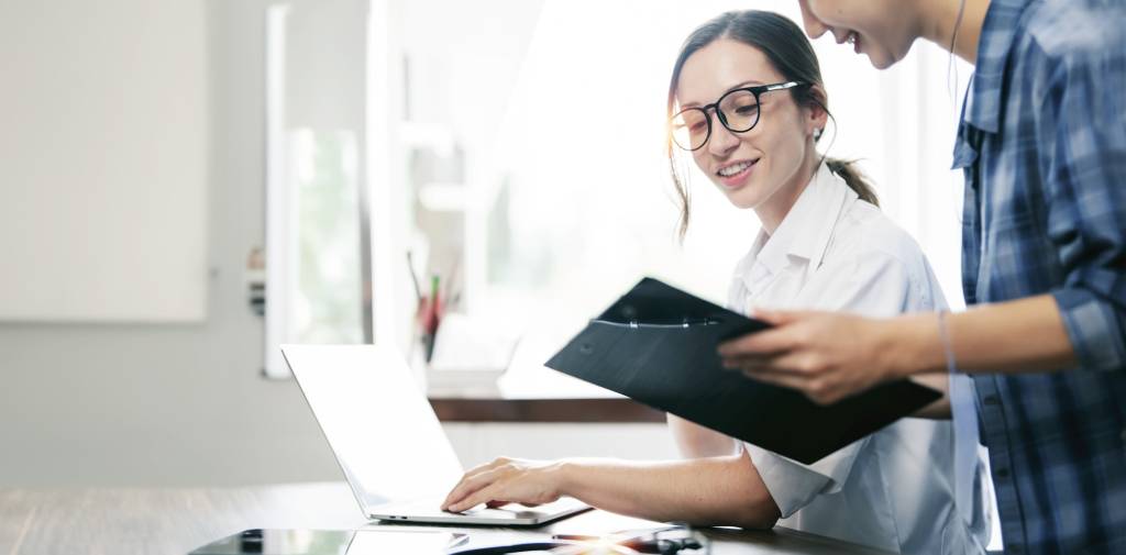 Two young business people working together